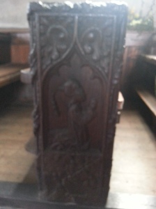 image of man in pigtail on bench end at High Bickington