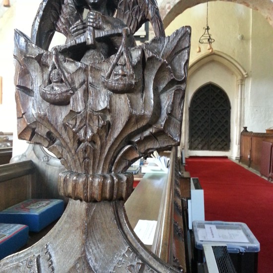 Image of bench end at Ickleton Church showing St Michael
